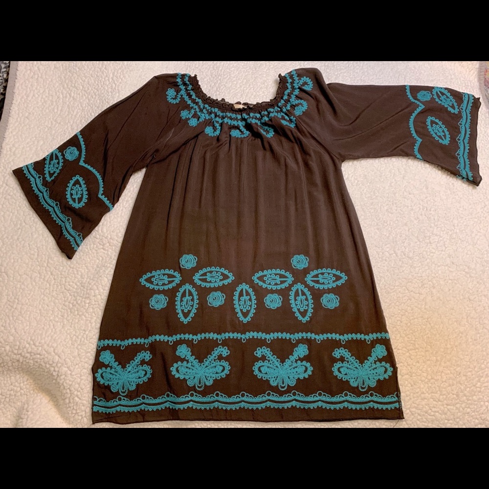 Brown dress with turquoise embroidery.